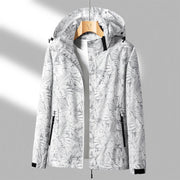 Damen Windjacke mit Kapuze – Leichte, wasserdichte Outdoor-Jacke mit floralem Print in Blau oder Rosa