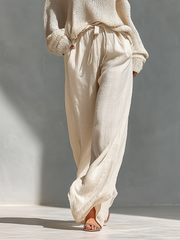 Set aus einem gestrickten Damen-Rollkragenpullover mit Cold-Shoulder-Ausschnitt und einer Hose mit weitem Bein