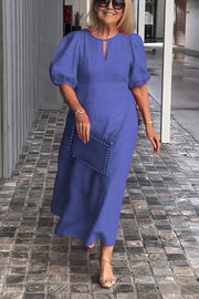 "Natalia | Zeitloses Eleganzkleid" could be rewritten as "Natalia | Klassisches Eleganzkleid".